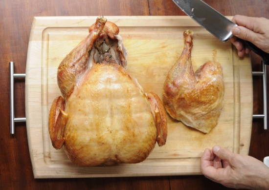 Next, remove the legs from the turkey by inserting your carving knife into joint where the thigh attaches to the body.