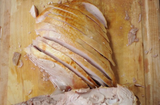 Slice the turkey breast perpendicular to the cuts you made to remove it from the carcass (against the grain). 